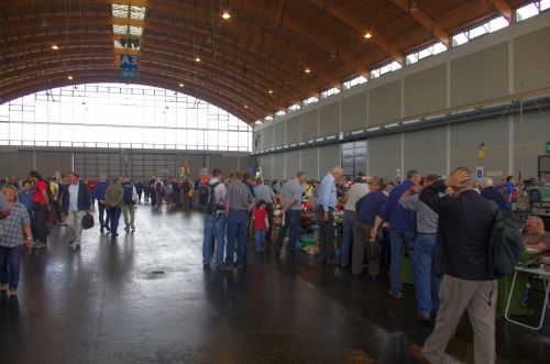 Flohmarkthallen: lange Tischreihen mit Waren von Schrott bis HF-High-Tech